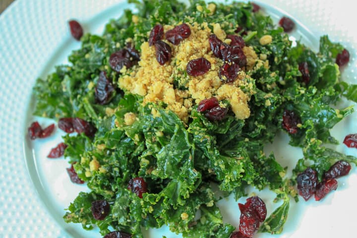 kale salad on a white plate. 