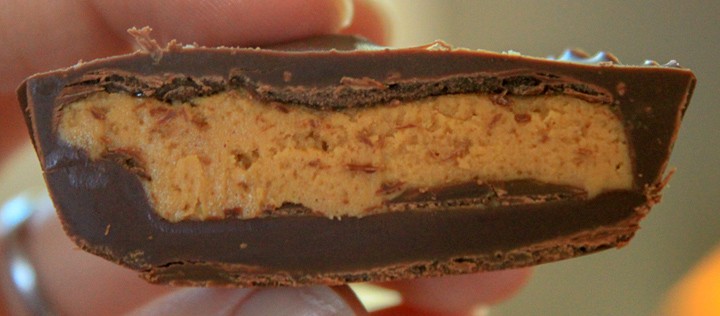 vegan peanut butter cup cut in half close up photo. 