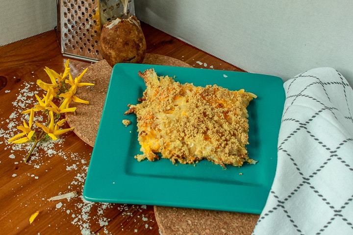 vegan cheesy hashbrowns on a blue plate. 