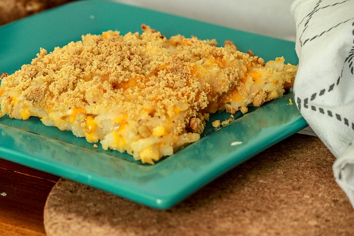 vegan funeral potatoes square piece on a square teal plate. 