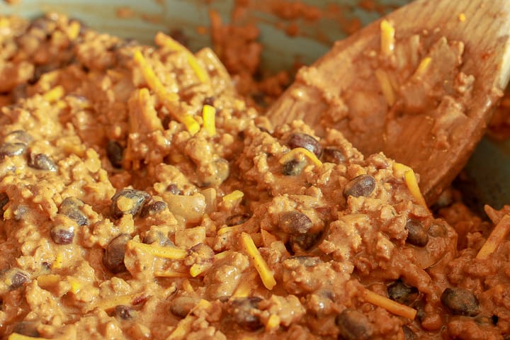 Taco pie filling close up with a wooden spoon. 