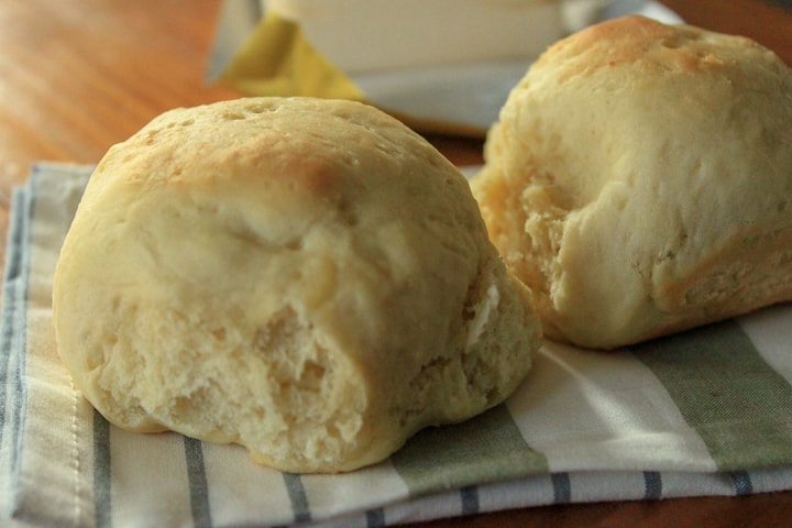 two vegan dinner rolls on a colorful napkin. 