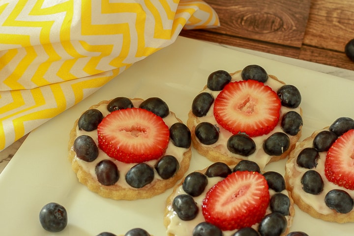 vegan mini fruit pizzas on a white plate. 