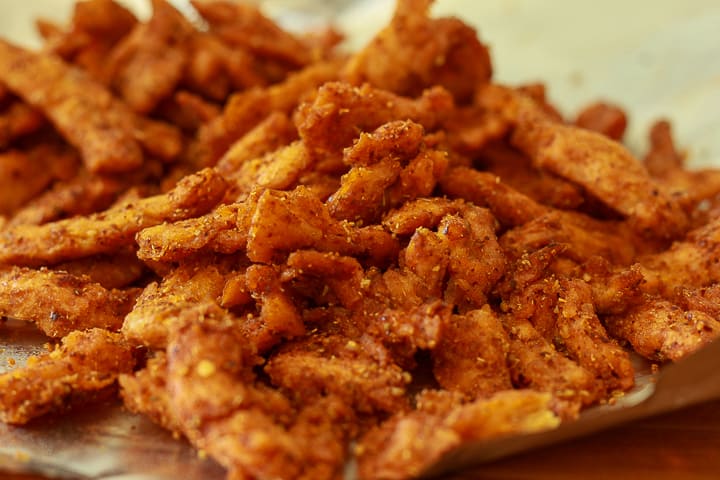 vegan pepperoni soy curls piled on a plate. 