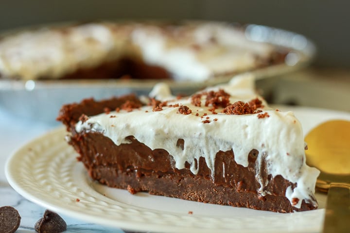 vegan chocolate cream pie slice on a white plate. 