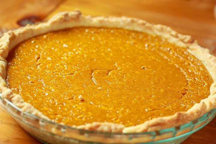 a whole vegan pumpkin pie in a glass pie dish. 