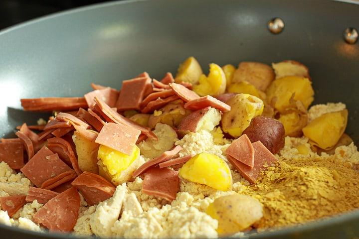 vegan breakfast burrito filling cooking in a frying pan. 