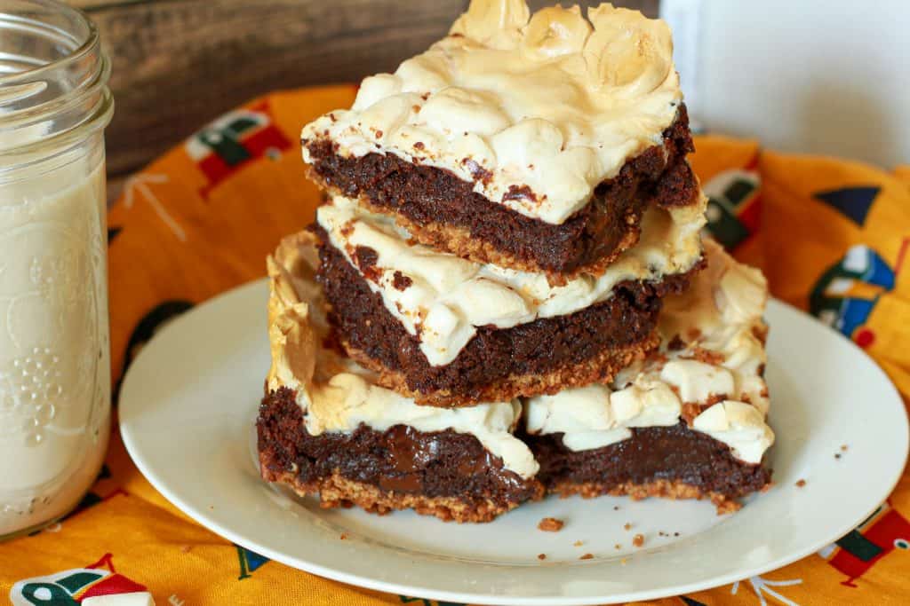 vegan smores brownies stacked on a white plate. 