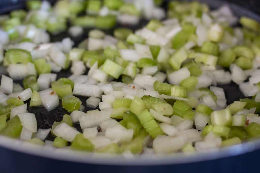 onions and celery cooking in a skillet. 