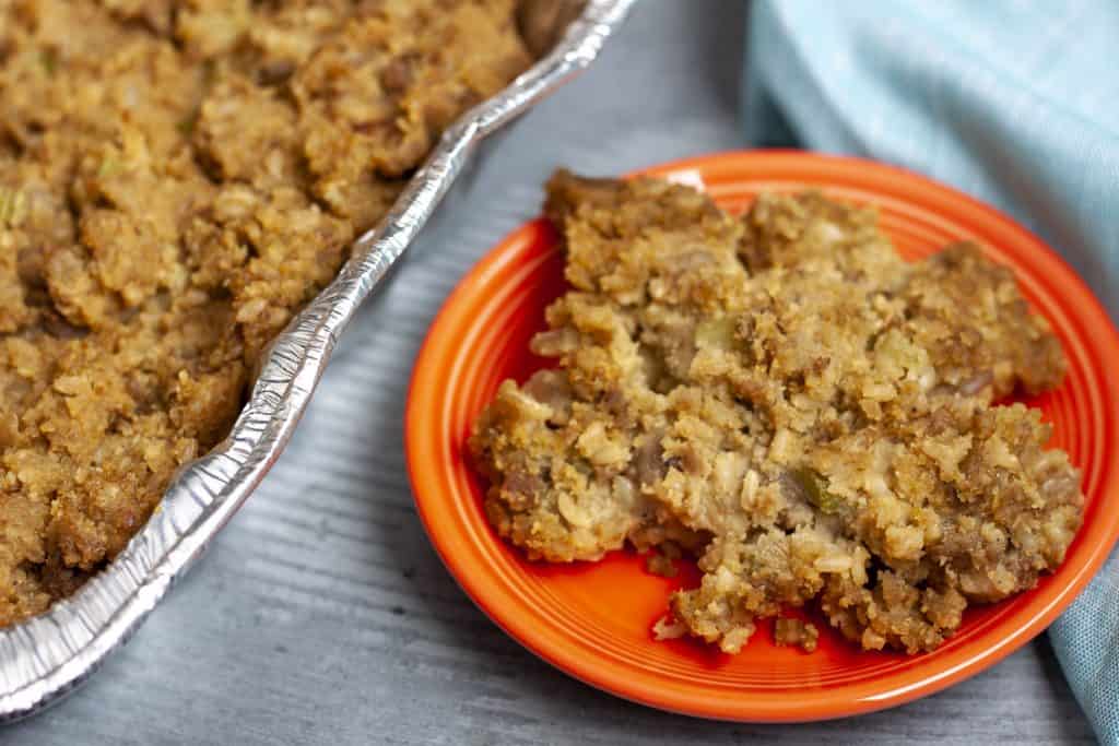 Vegan cornbread stuffing on an orange plate. 