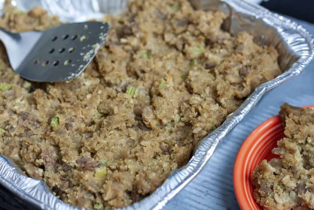 vegan stuffing cooked in an 8x8 silver pan. 