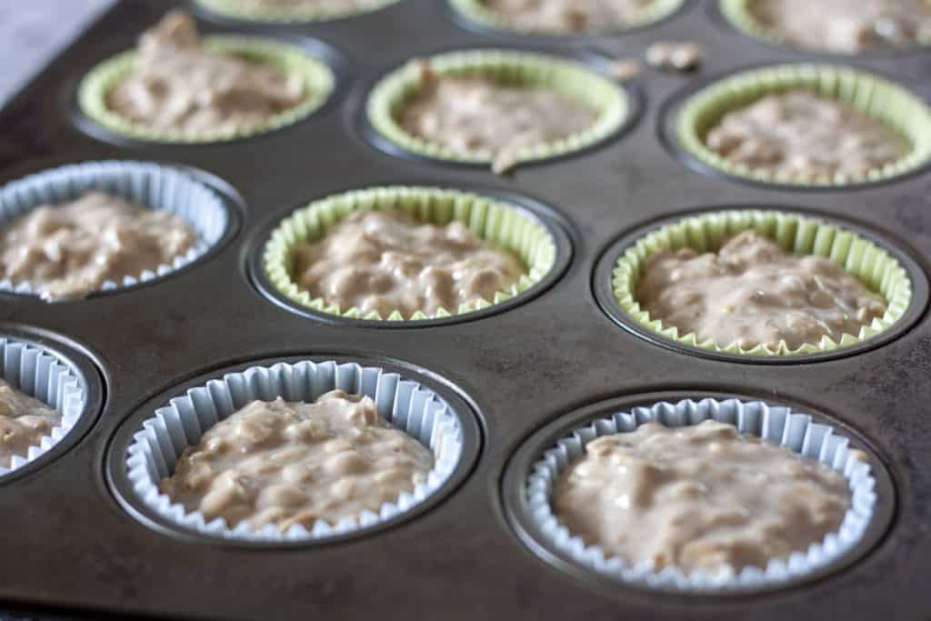 Vegan Oatmeal Muffins precooked in a muffin tin. 