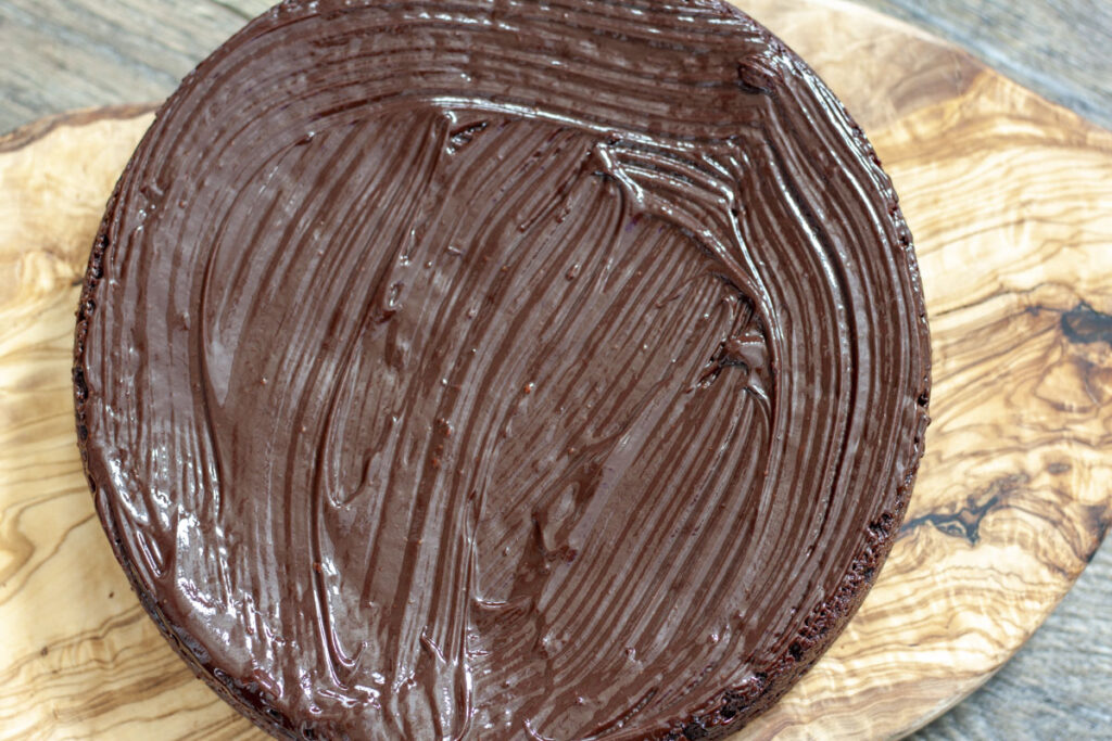 frosting the vegan chocolate cake.