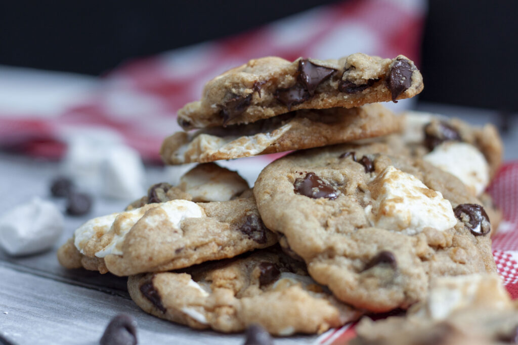 Vegan smores cookie in a pile on a checkered white and red napkin. 