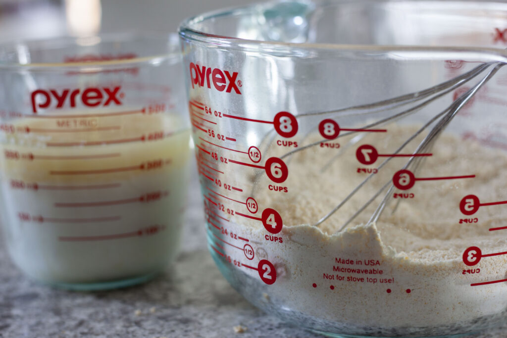 wet ingredients in a glass bowl as well as the dry ingredients in a glass bowl with a whisk. 