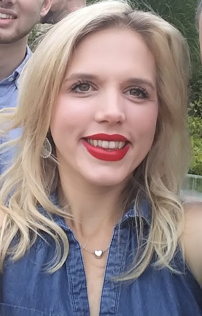 a photo of a women with blonde hair and red lipstick. 