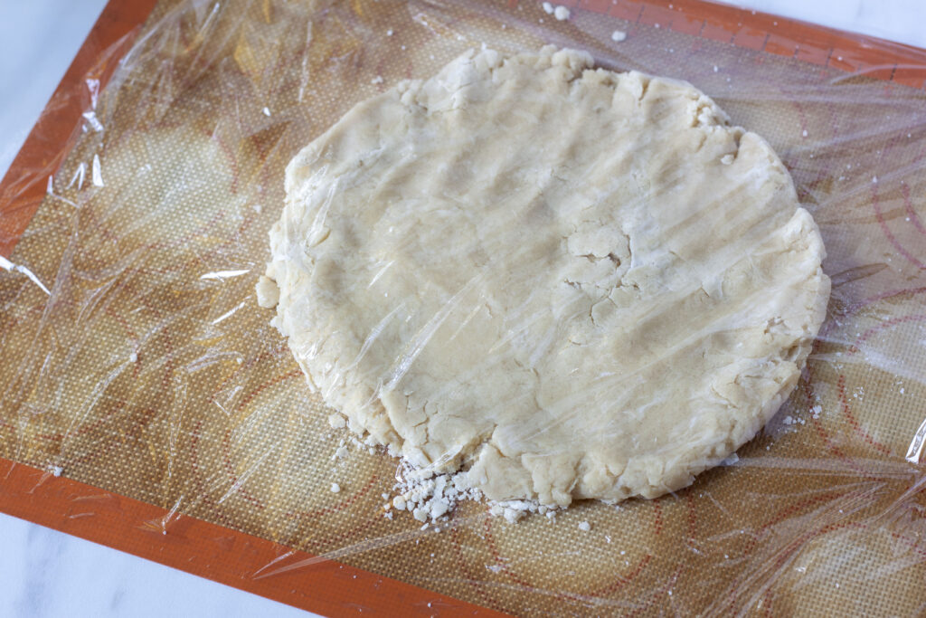 pat your pastry dough in a circle before rolling your pie crust on a silpat with plastic wrap over it.