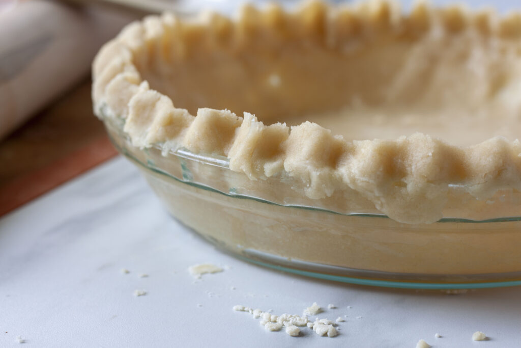 pie crust crimped edges on a pie plate.