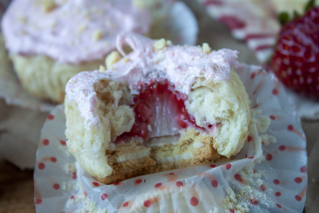 vegan strawberry shortcake cupcake with a strawberry in the middle