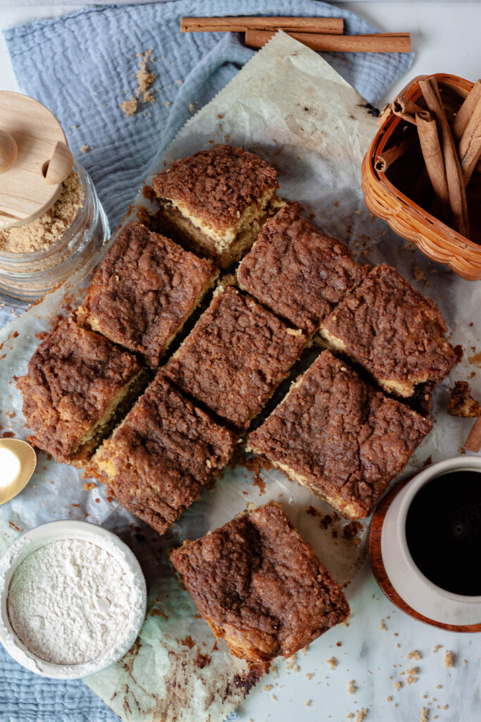 vegan coffee cake 8x8 shape cut into even squares on a paper background.