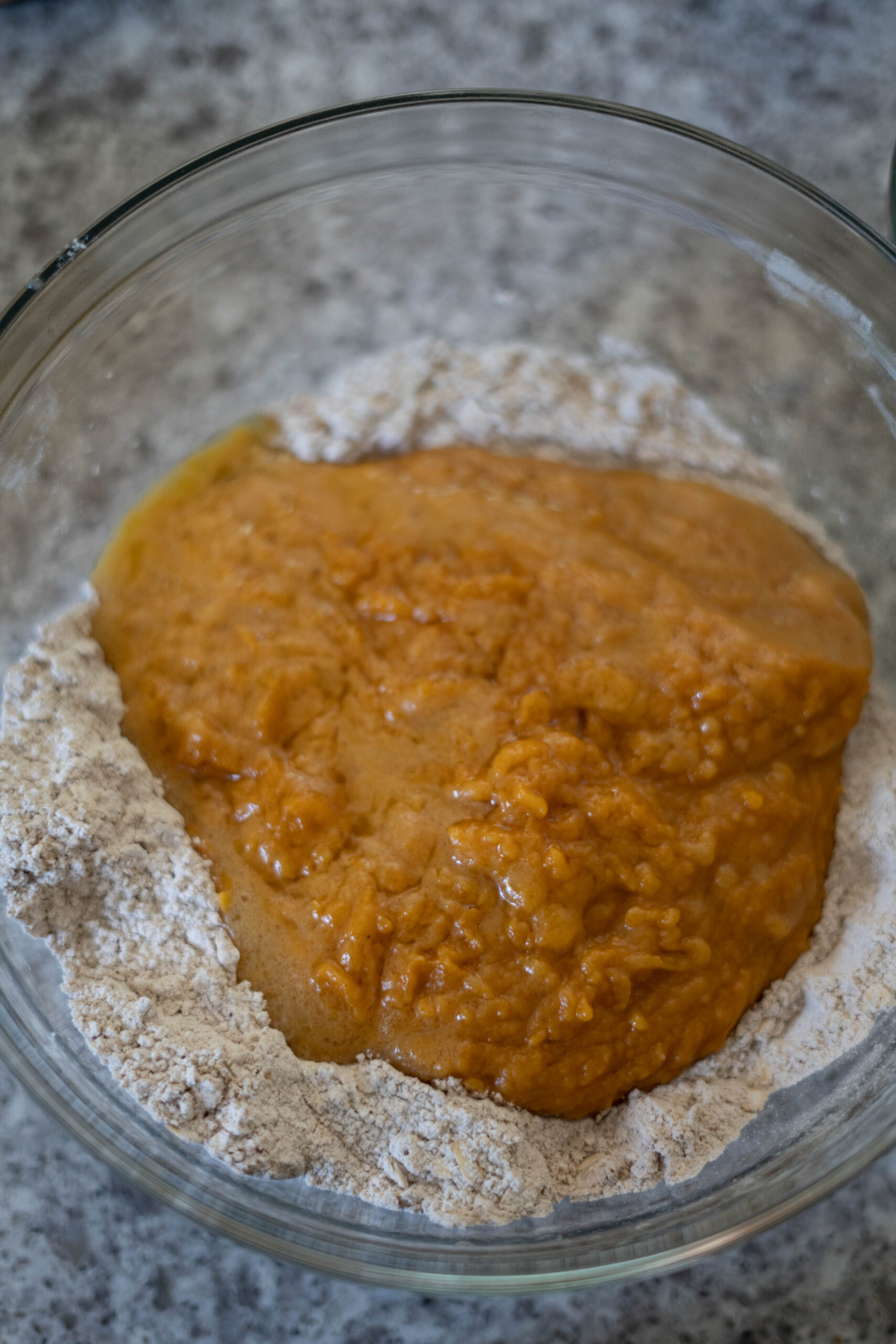 vegan pumpkin muffin wet and dry ingredients in a clear bowl. 