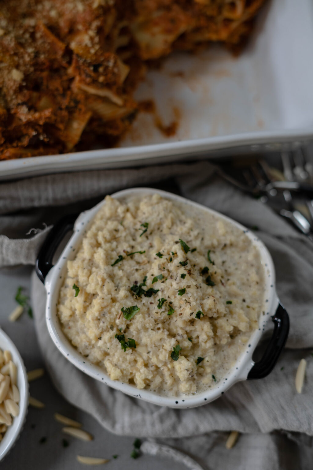 A bowl of creamy homemade vegan ricotta cheese substitute garnished with fresh herbs