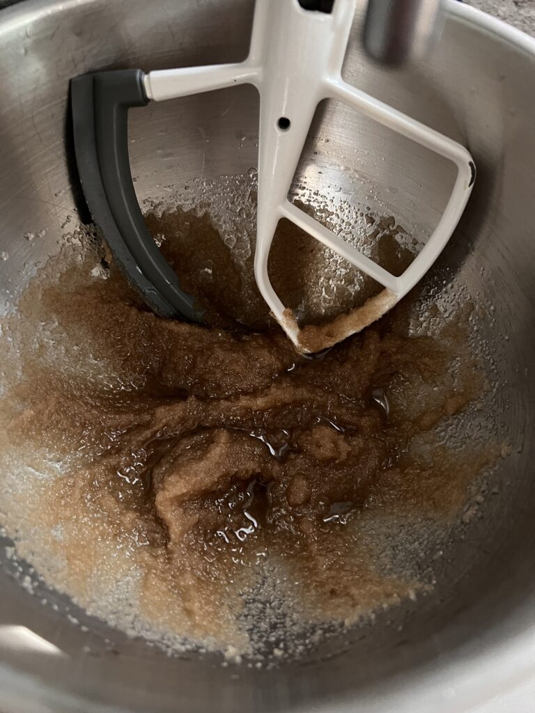 mixing oil and sugars in a kitchen add mixer. 
