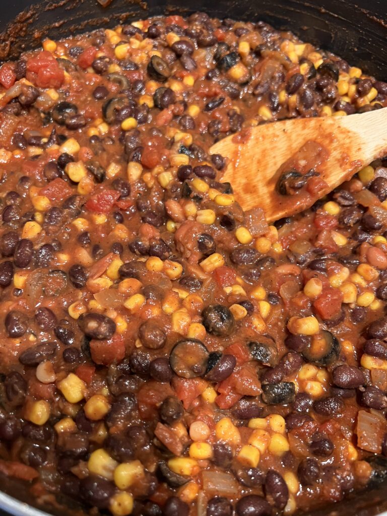 Add the beans, corn, olives, etc