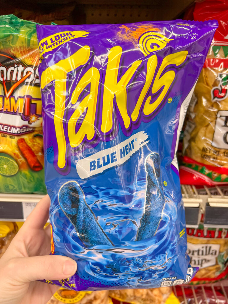 Blue Taki bag Heald up in the chip aisle. 