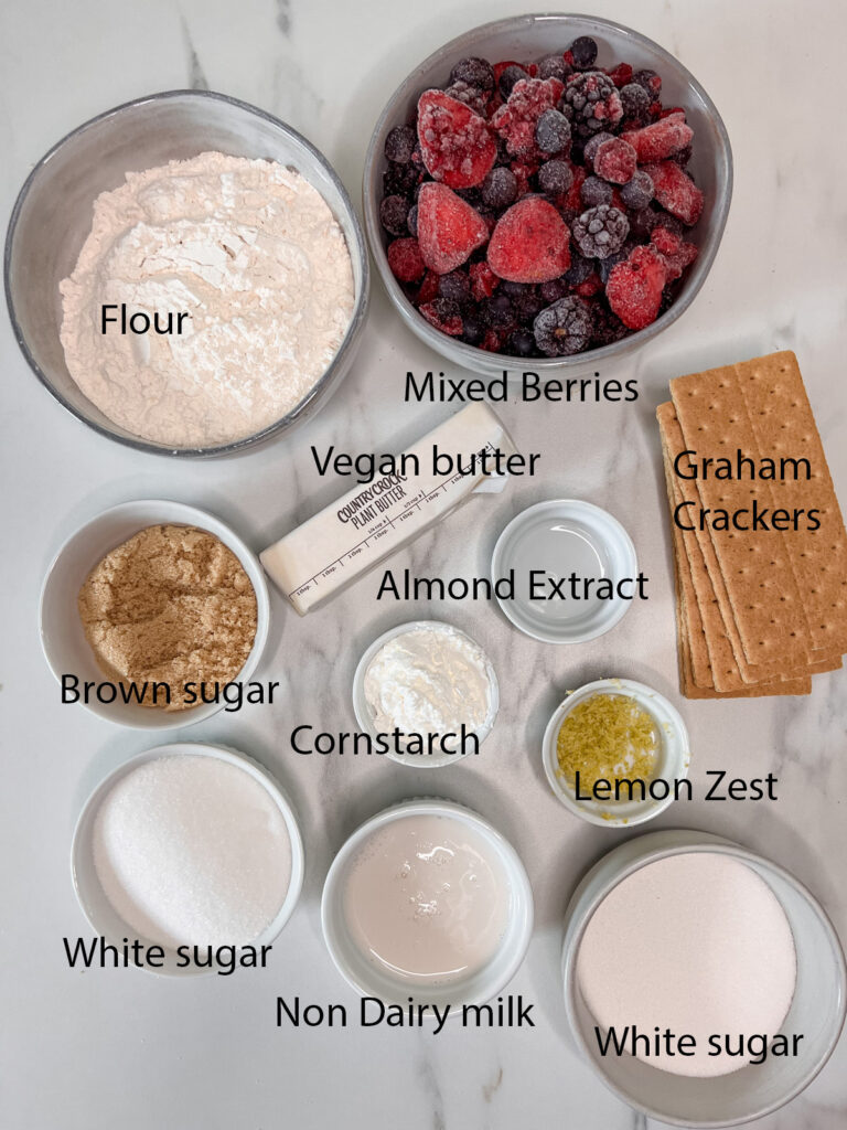 All of the ingredients in the berry bars in containers on a white background. 