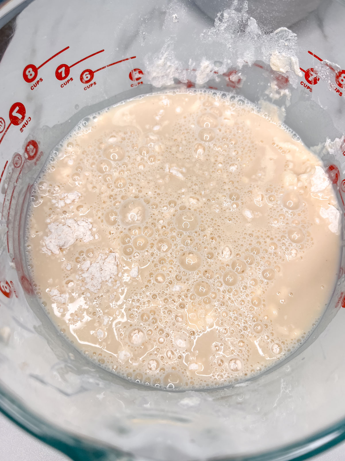 When the wet ingredients get added to the dry ingredients looks like a puddle of milk in a glass bowl. 