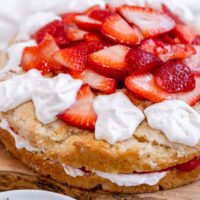 vegan strawberry shortcake on a wood platter.