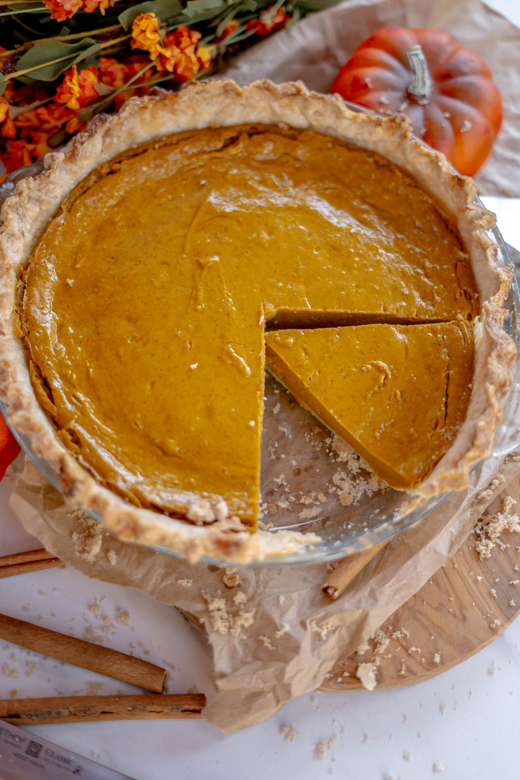 Vegan pumpkin pie with two slices out of it. 