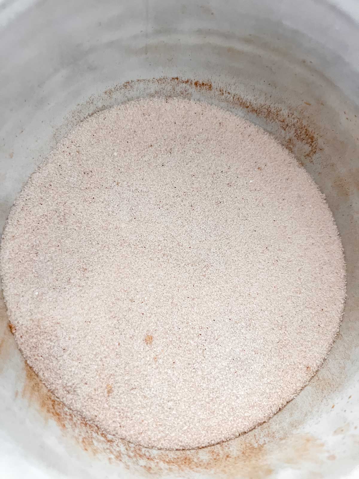 Cinnamon and sugar in a light grey bowl. 