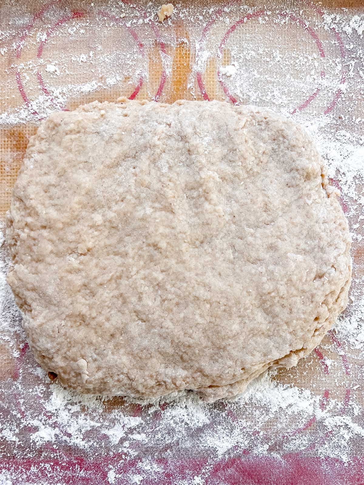 Half the vegan apple cider donut dough on a floured silpat before rolling out. 