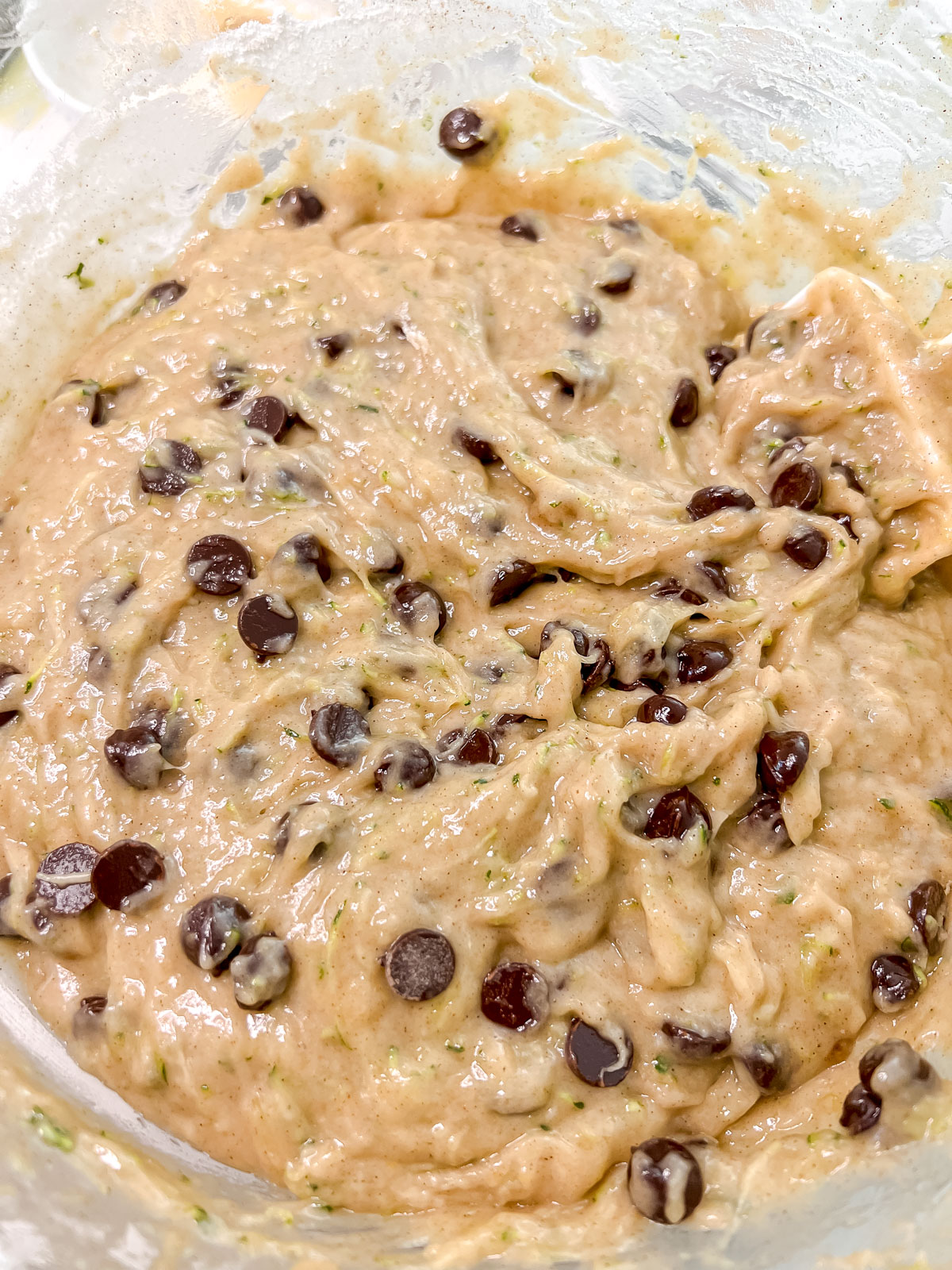 In a clear bowl the vegan zucchini bread batter with chocolate chips. 