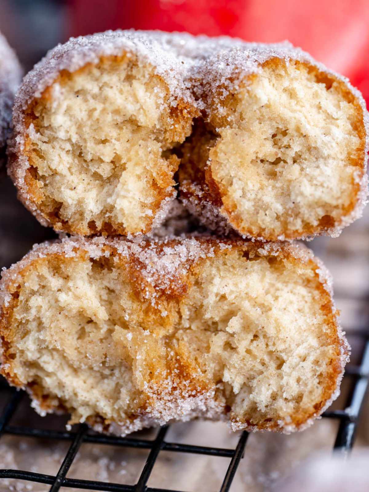 One donut cut in half stacked on top of each other with the inside open. 